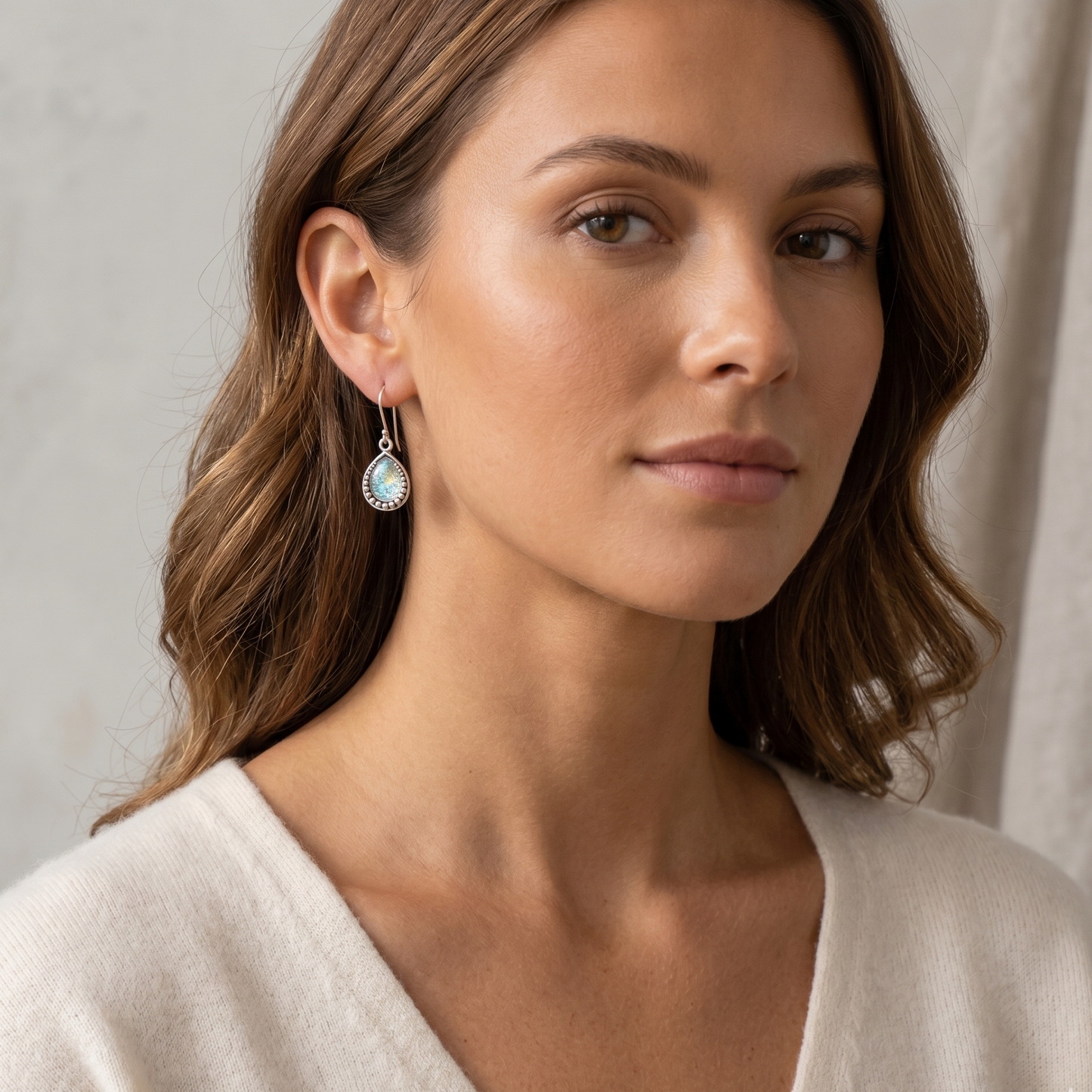 Woman wearing a white top with a neutral background