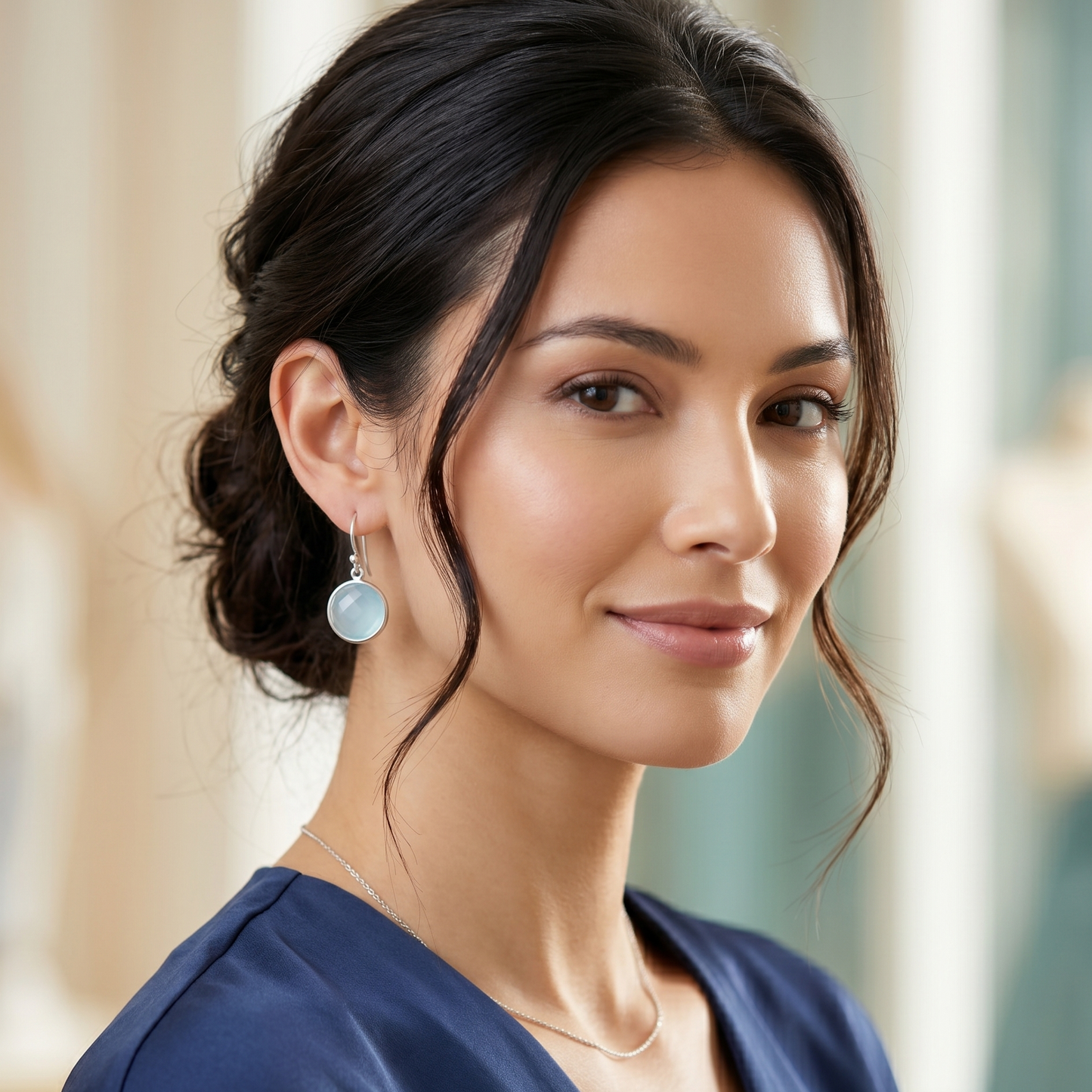 Woman wearing earrings with a blurred background