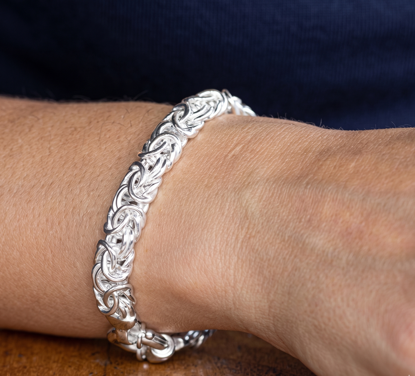 Silver bracelet on a wrist with a blurred background