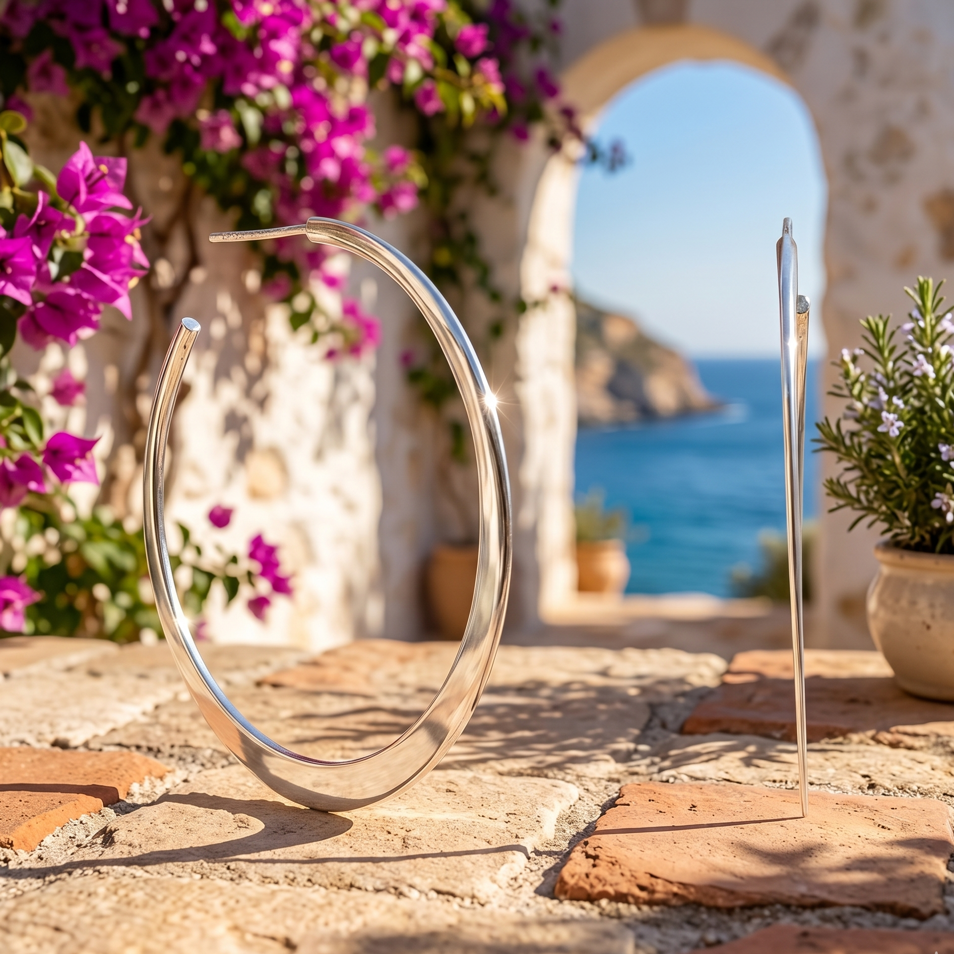 Silver circular object on a stone surface with flowers and a scenic background