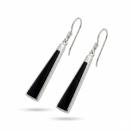 Pair of silver earrings with black triangular stones on a white background