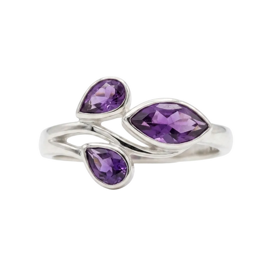 Silver ring with purple gemstones on a white background