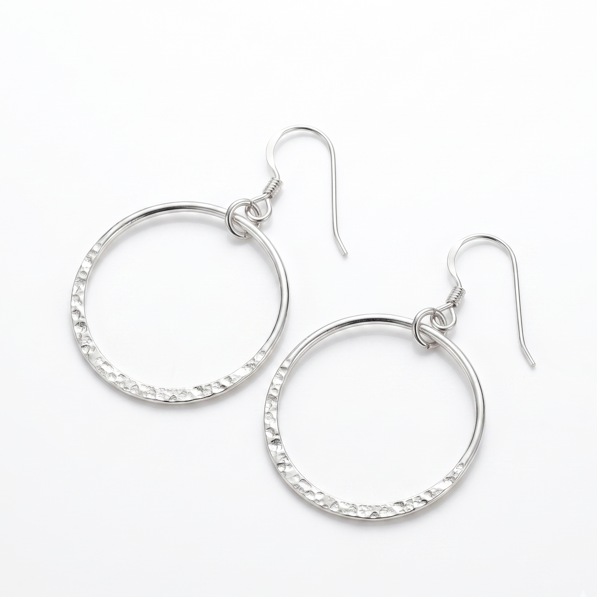 Pair of silver hoop earrings on a white background