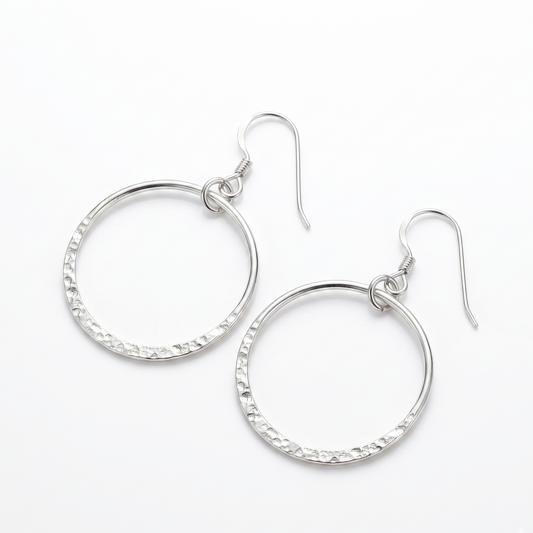Pair of silver hoop earrings on a white background