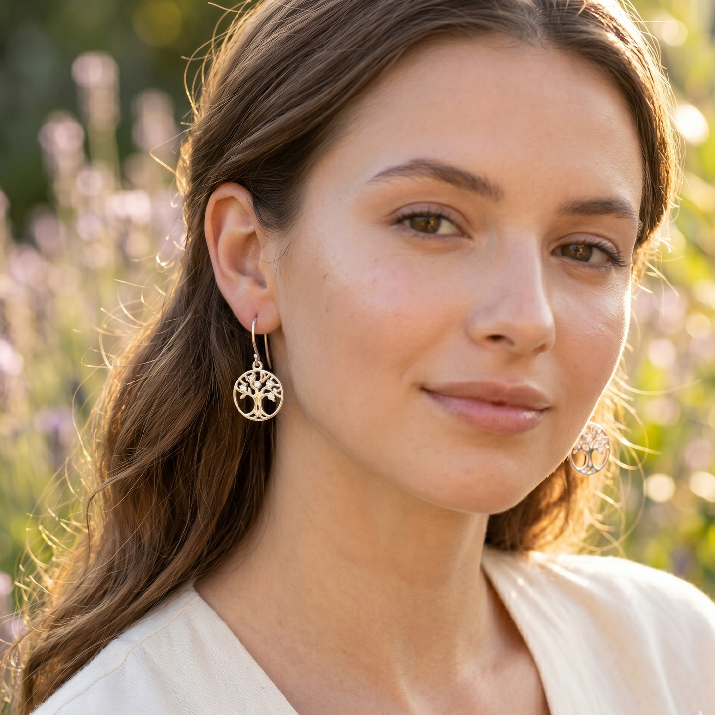 Woman wearing earrings with a blurred natural background