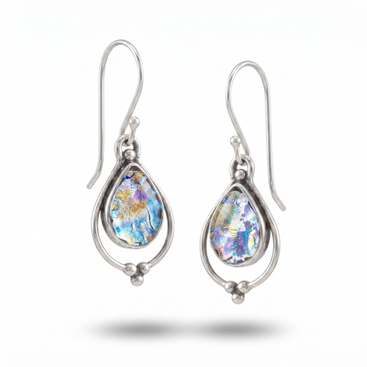 Teardrop-shaped earrings with floral design on a white background