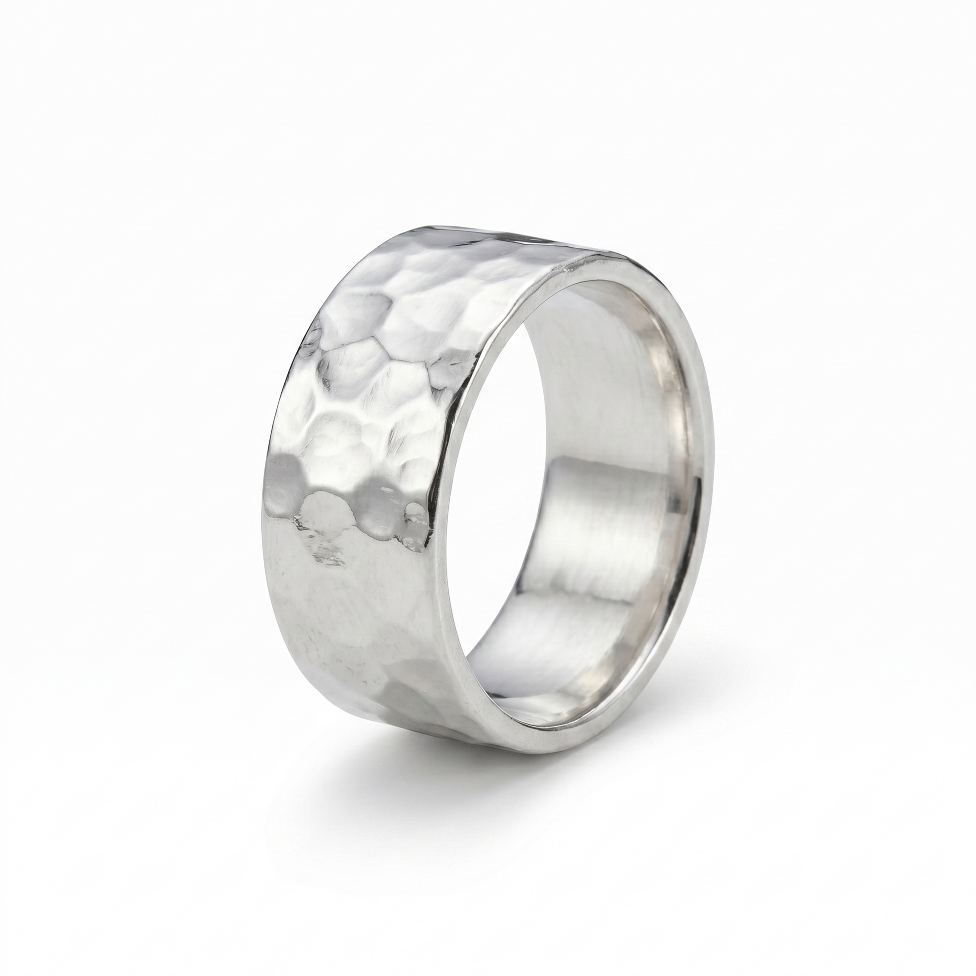 Silver ring with a textured surface on a white background