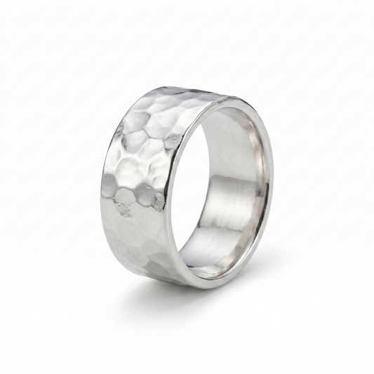 Silver ring with a textured surface on a white background