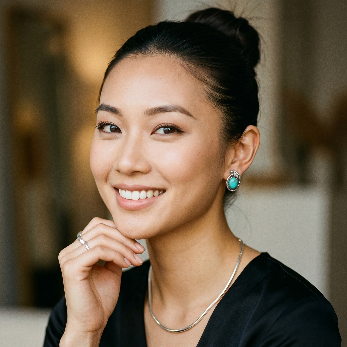 Woman wearing a black top with a blurred background