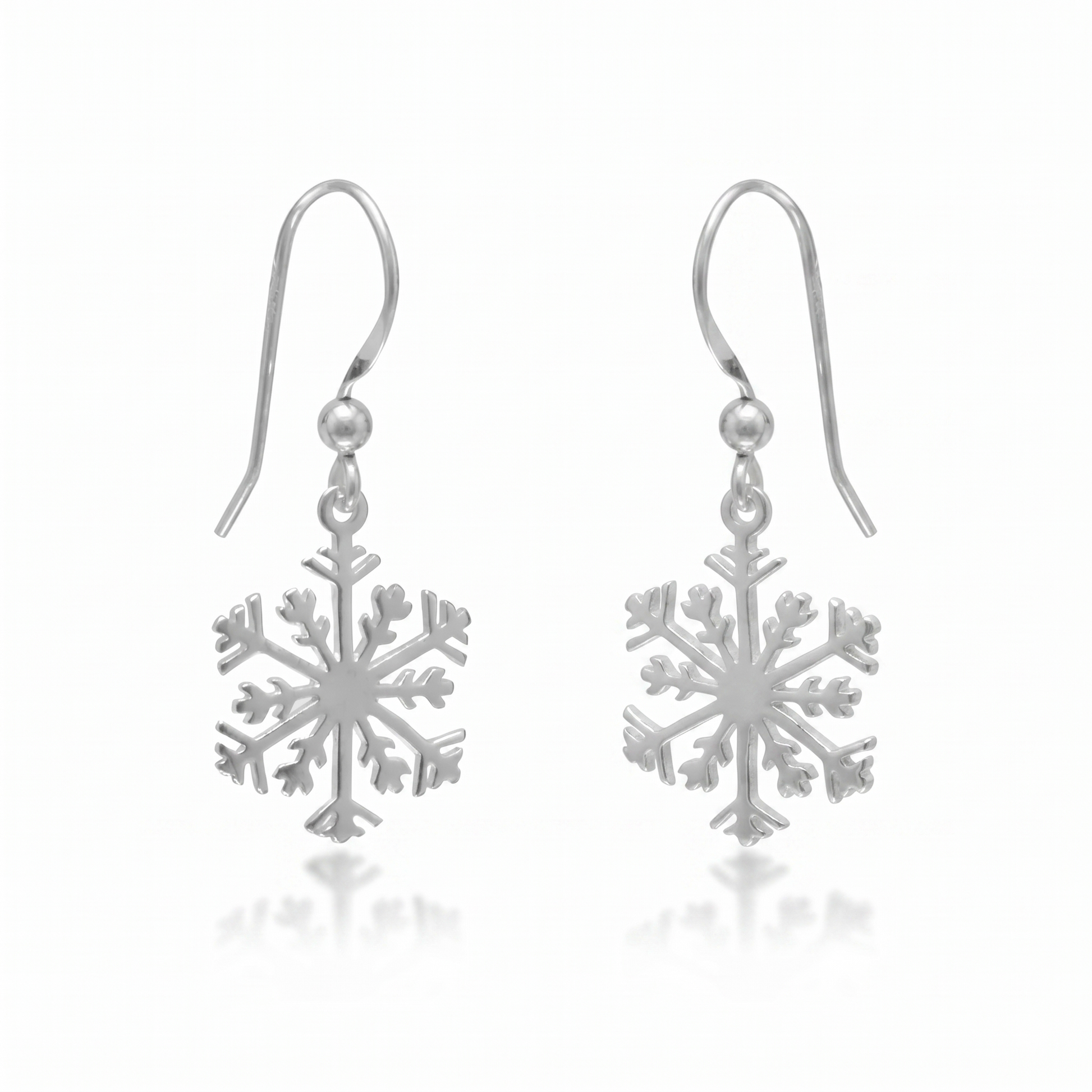 Silver snowflake earrings on a white background