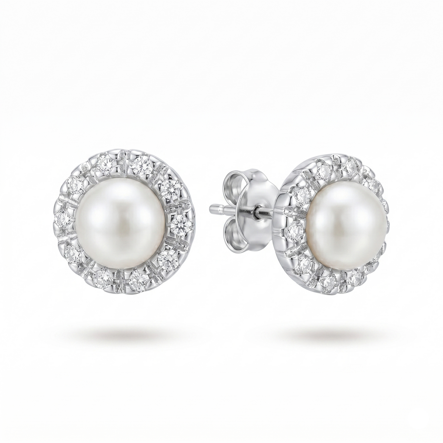 Pearl earrings with silver setting on a white background