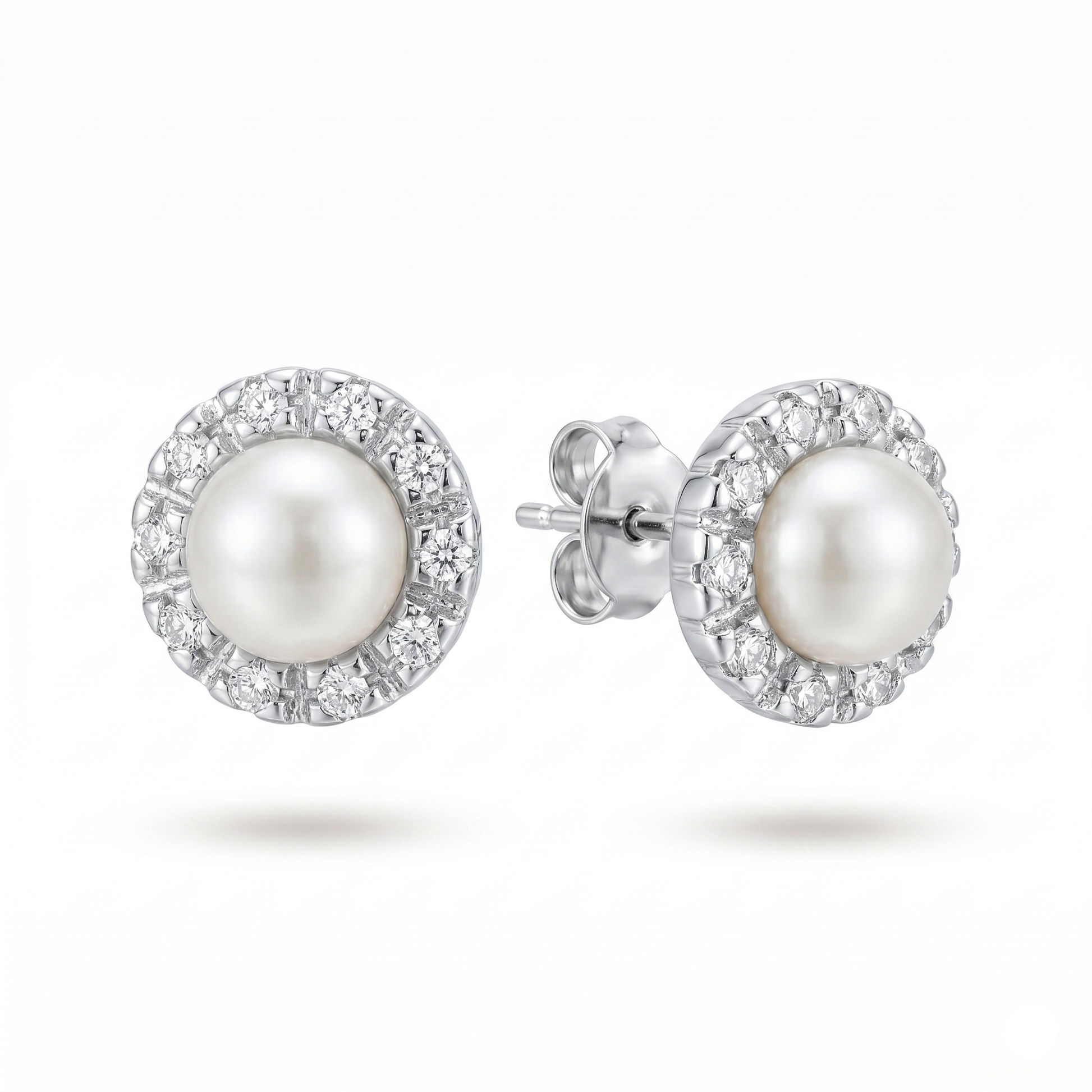 Pearl earrings with silver setting on a white background