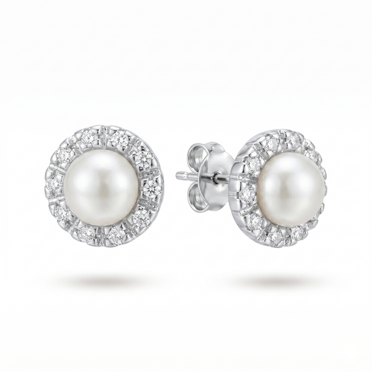 Pearl earrings with silver setting on a white background