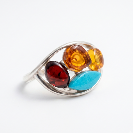 Silver ring with colorful gemstones on a white background