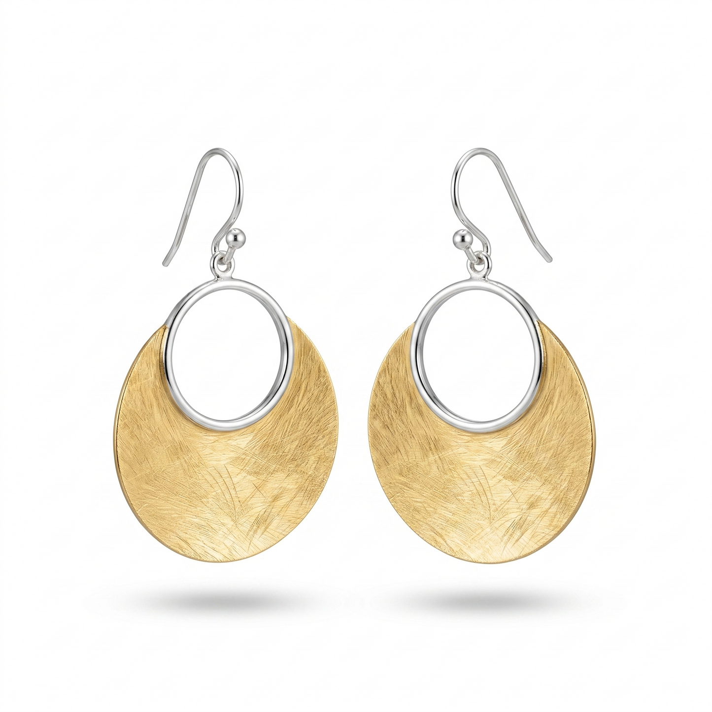 Gold and silver earrings on a white background