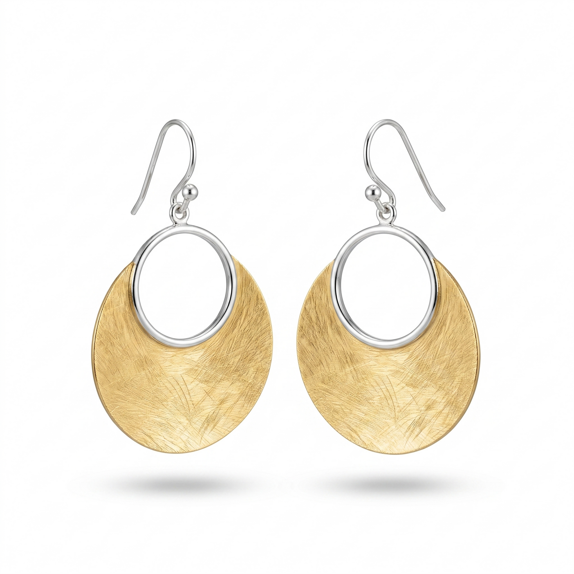 Gold and silver earrings on a white background