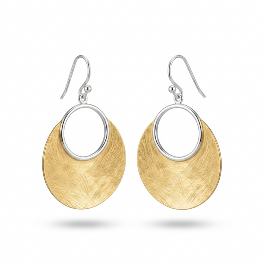 Gold and silver earrings on a white background