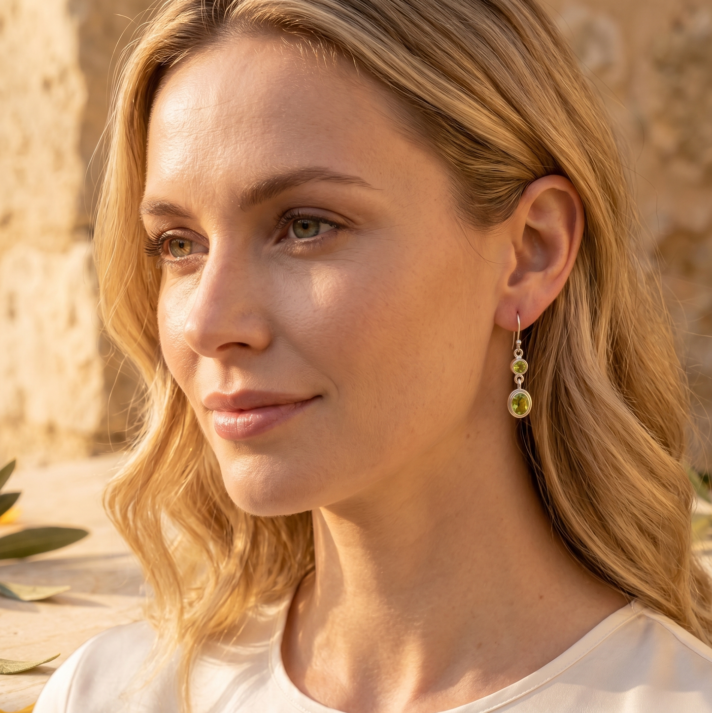 Woman wearing earrings with a neutral background