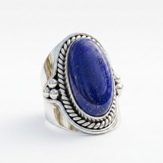 Silver ring with a blue stone on a white background