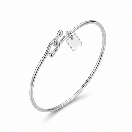 Silver bracelet with a tag on a white background