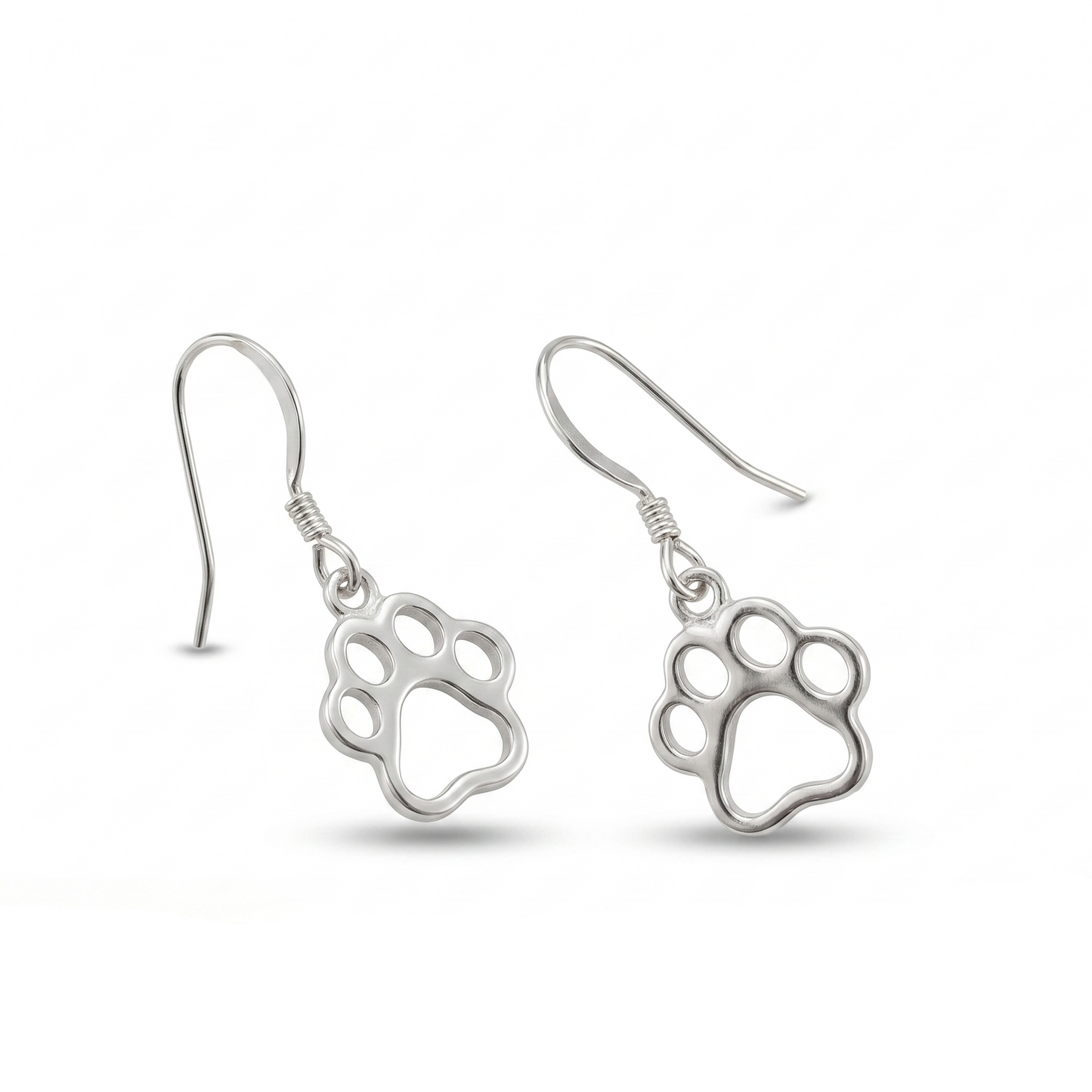 Silver paw print earrings on a white background with a wooden log and butterfly at the bottom.