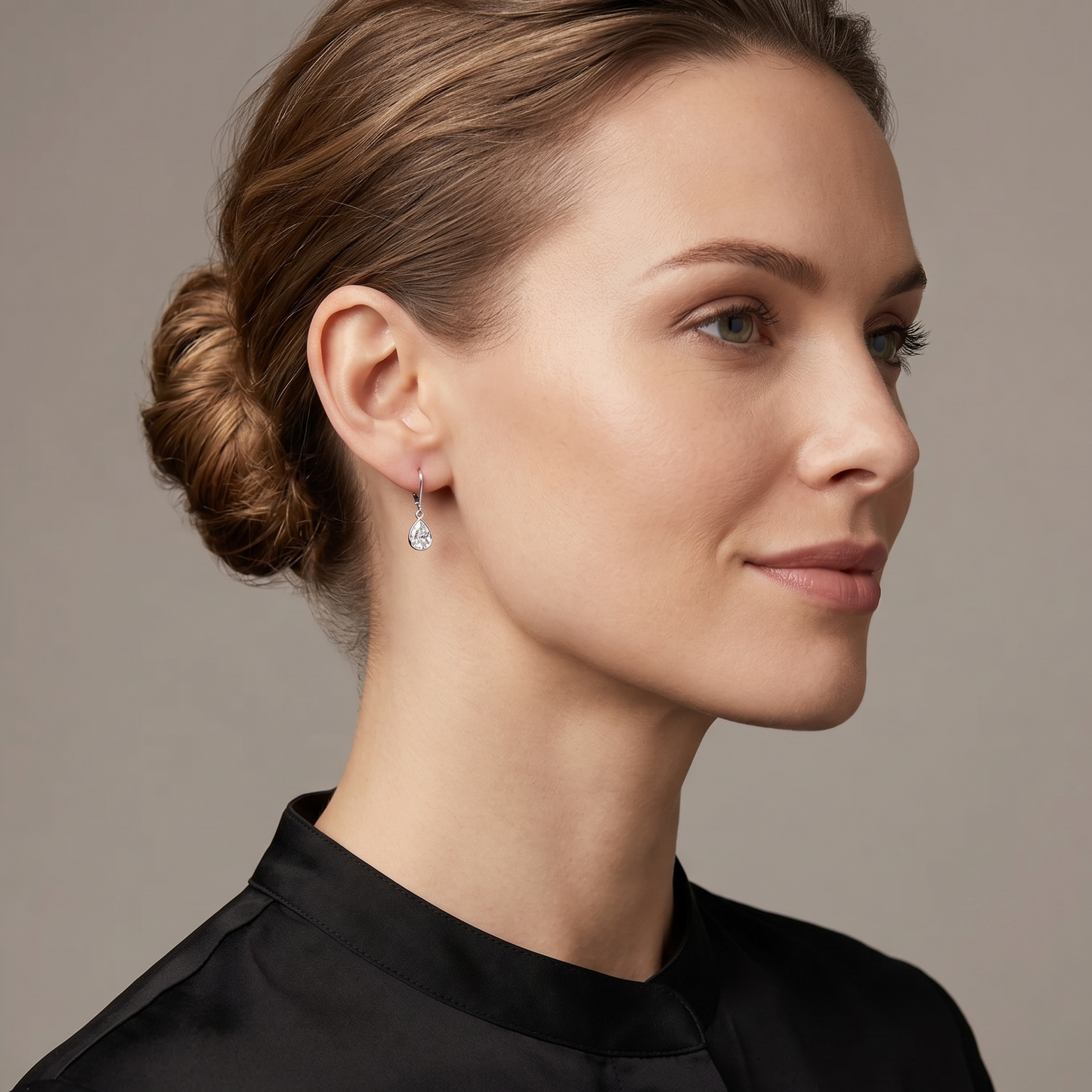 Woman wearing a black top with a neutral background
