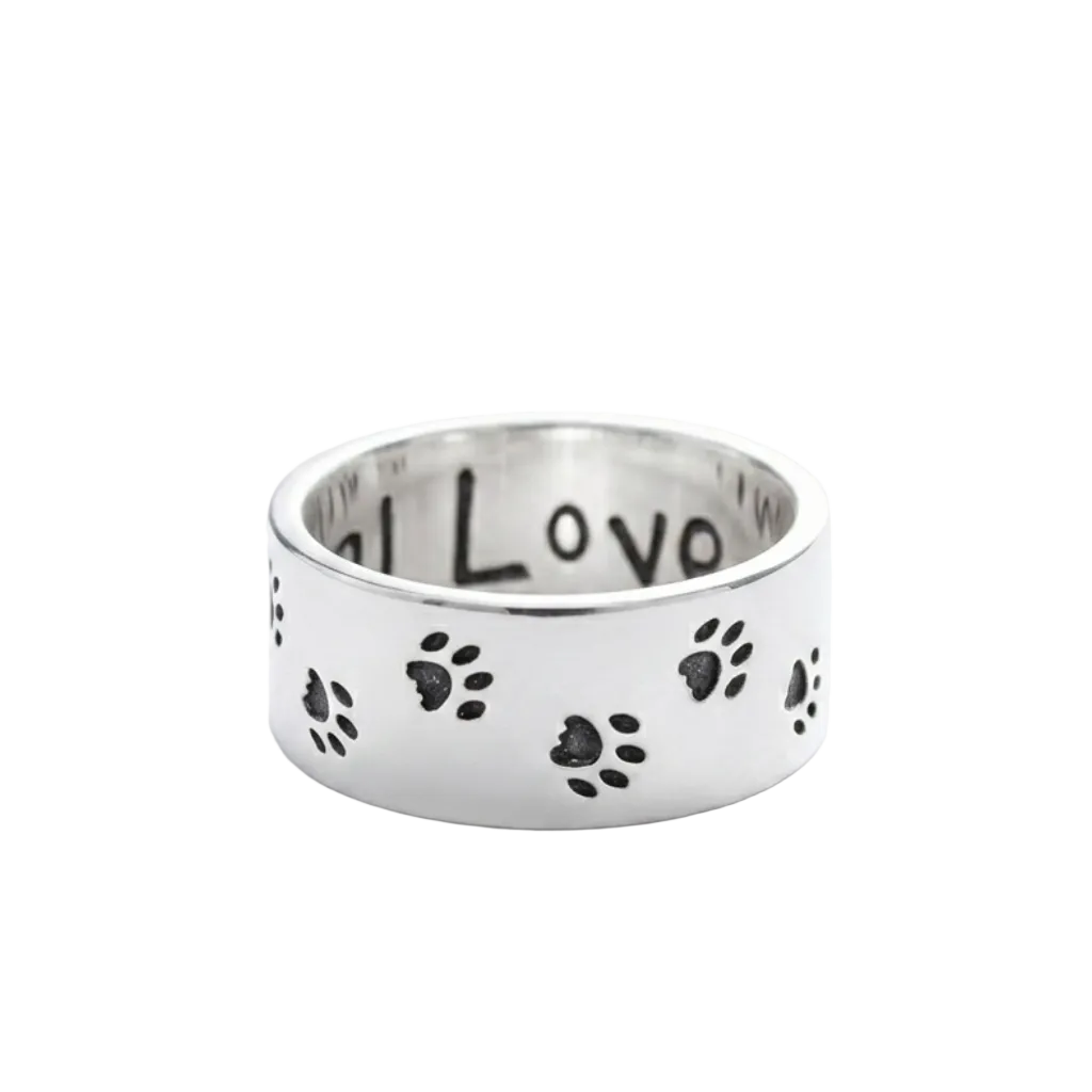 Silver ring with paw prints and 'I love' engraving on a white background
