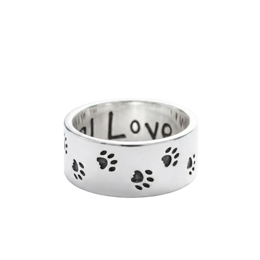 Silver ring with paw prints and 'I love' engraving on a white background