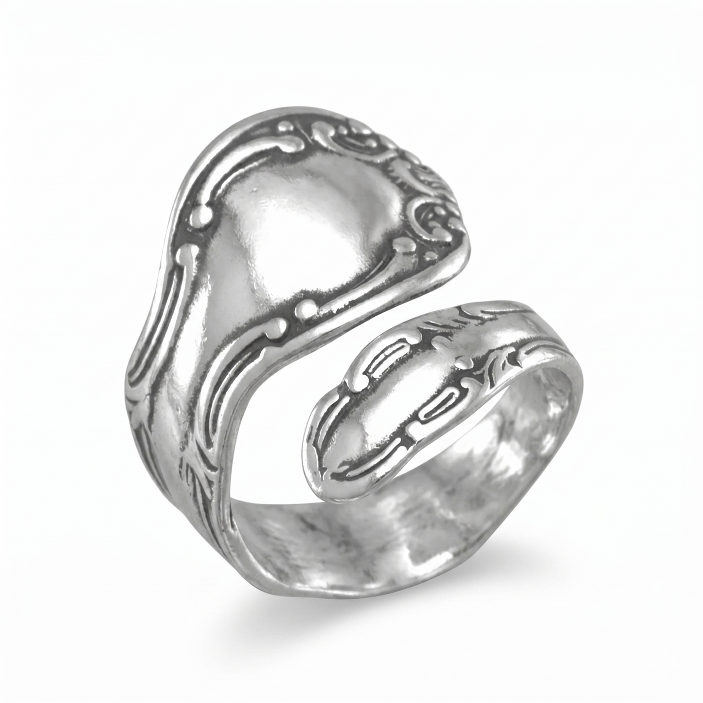 Silver ring with intricate design on a white background