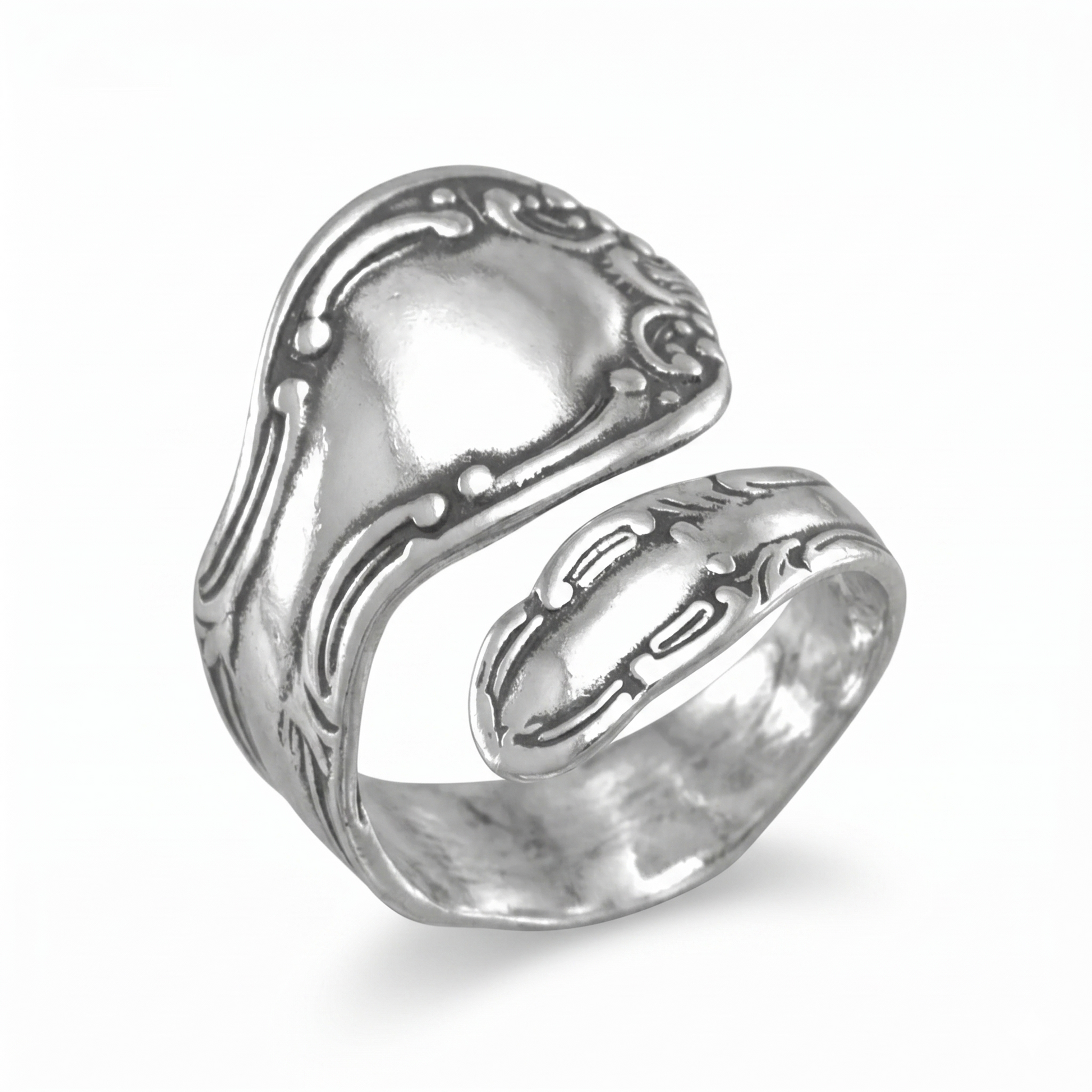 Silver ring with intricate design on a white background