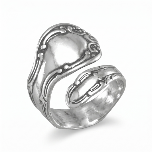 Silver ring with intricate design on a white background