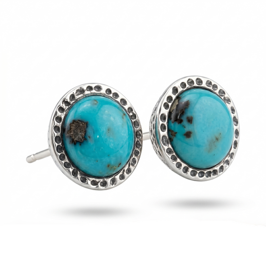 Turquoise stud earrings with silver detailing on a white background