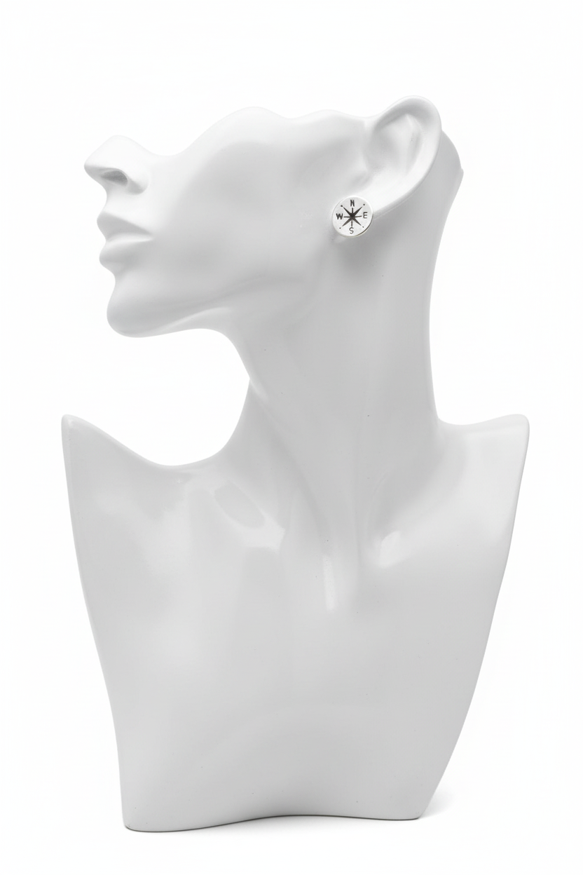 Compass stud earrings on white mannequin