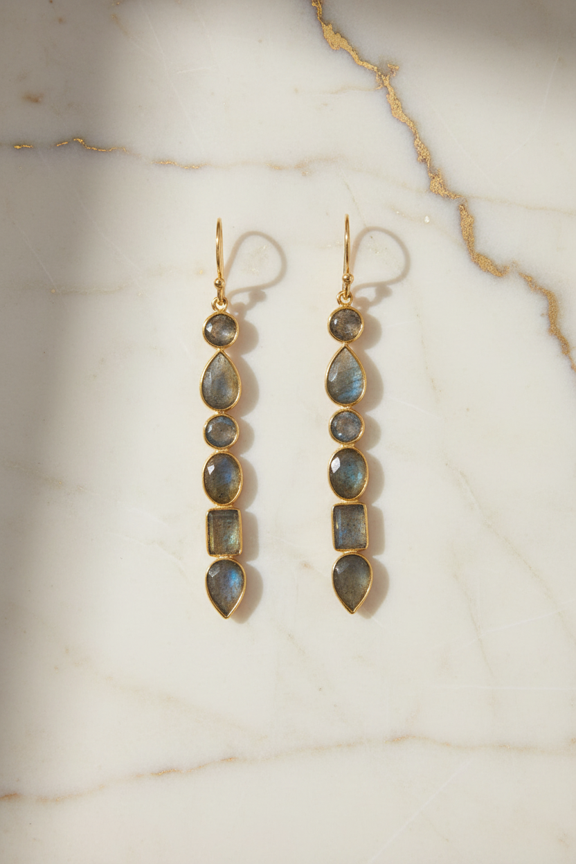 Earrings on cream marble with gold veining