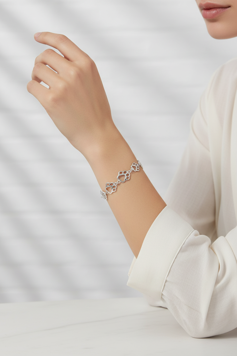 Female model wearing paw print bracelet - side angle