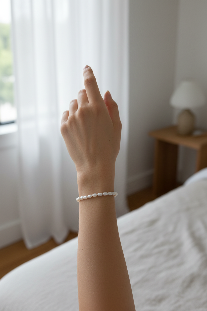 Female model wearing rice pearl bracelet - side angle