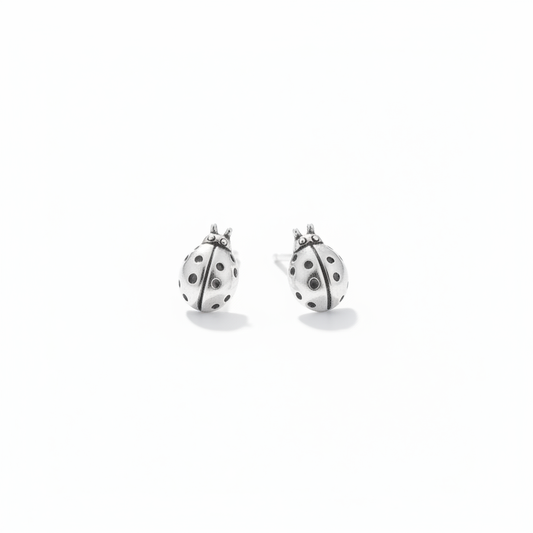 Pair of ladybug studs on white
