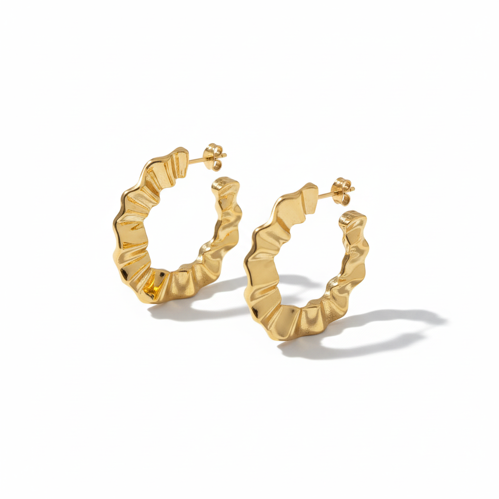 Pair of wavy hoop earrings on white