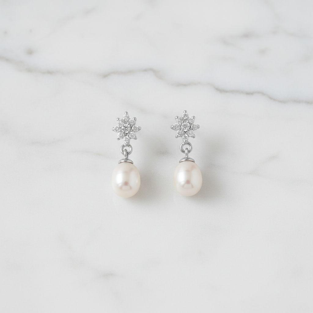 Pearl earrings on white marble