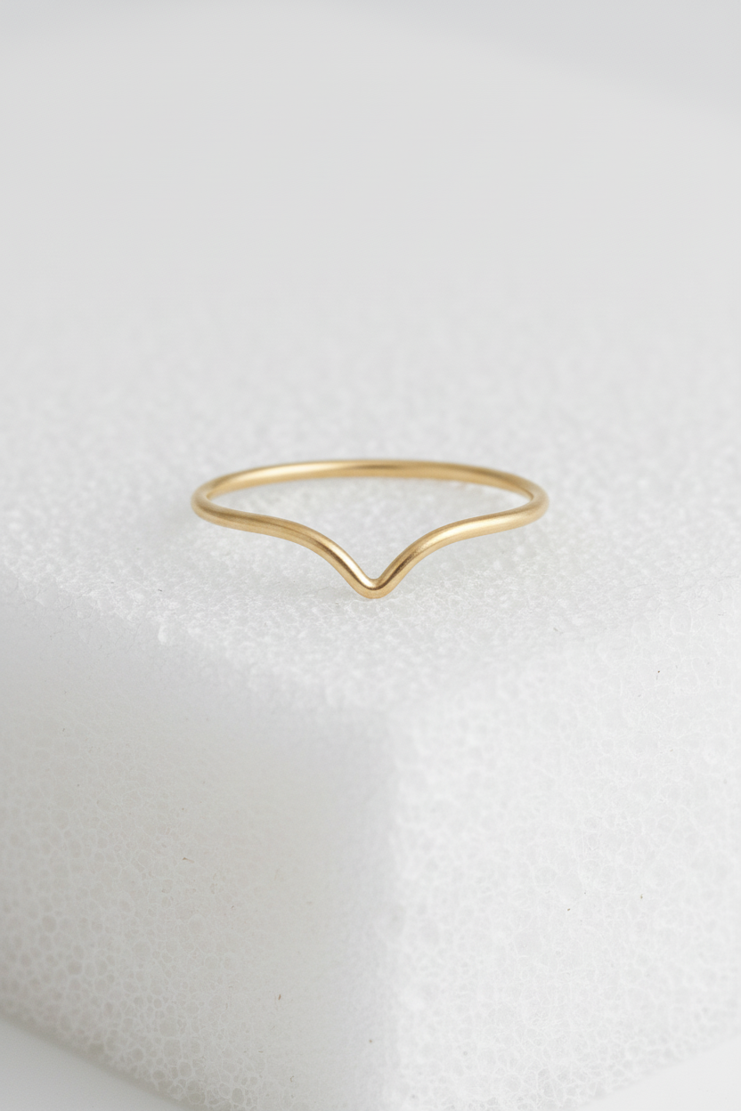 Plain Chevron V-Shape Gold Ring on Sponge Background