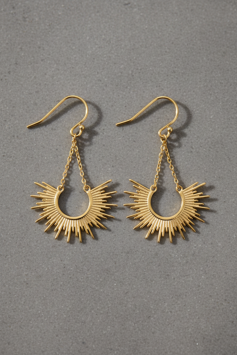Radiant sunburst cascade earrings on grey stone