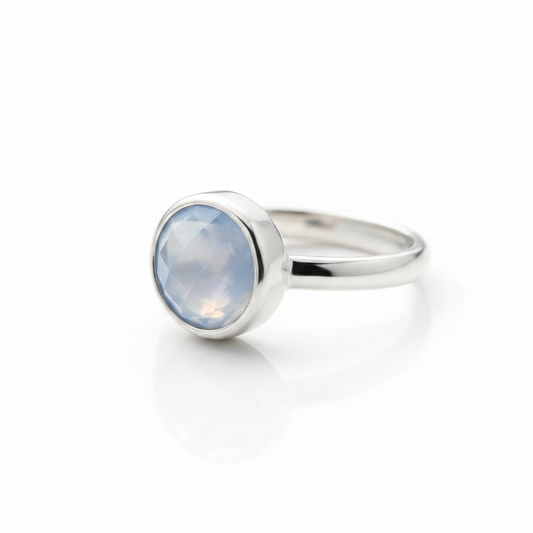 Round Blue Chalcedony Bezel Silver Ring Pure White Background Tilted Reflection Warm Inner Glow 1x1