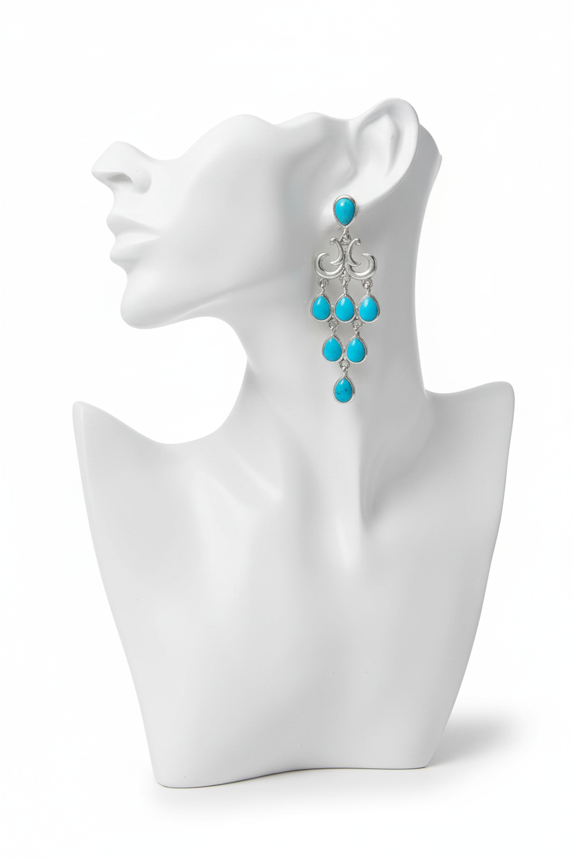 Turquoise earrings on white mannequin